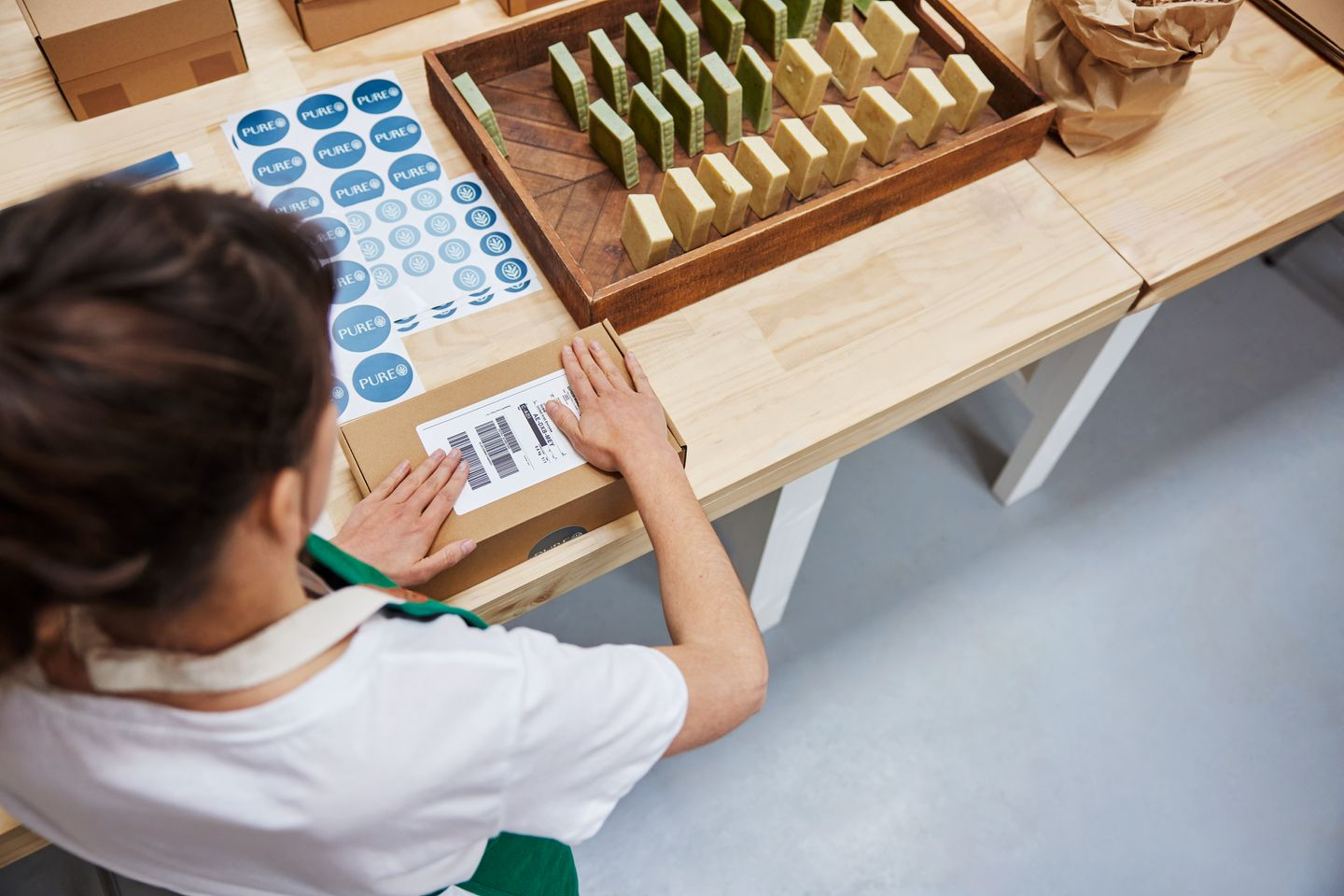 Female employee preparing herbal products for international shipping