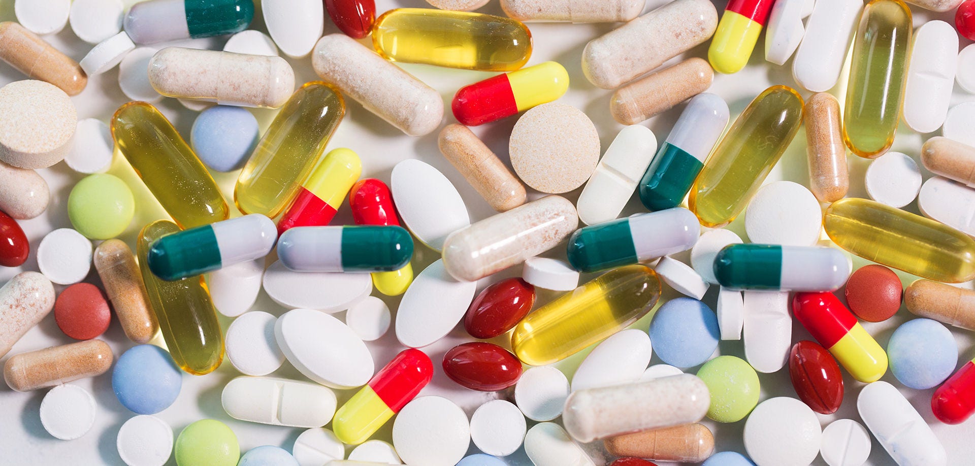 medicine, healthcare and pharmacy concept - different pills and capsules of drugs
