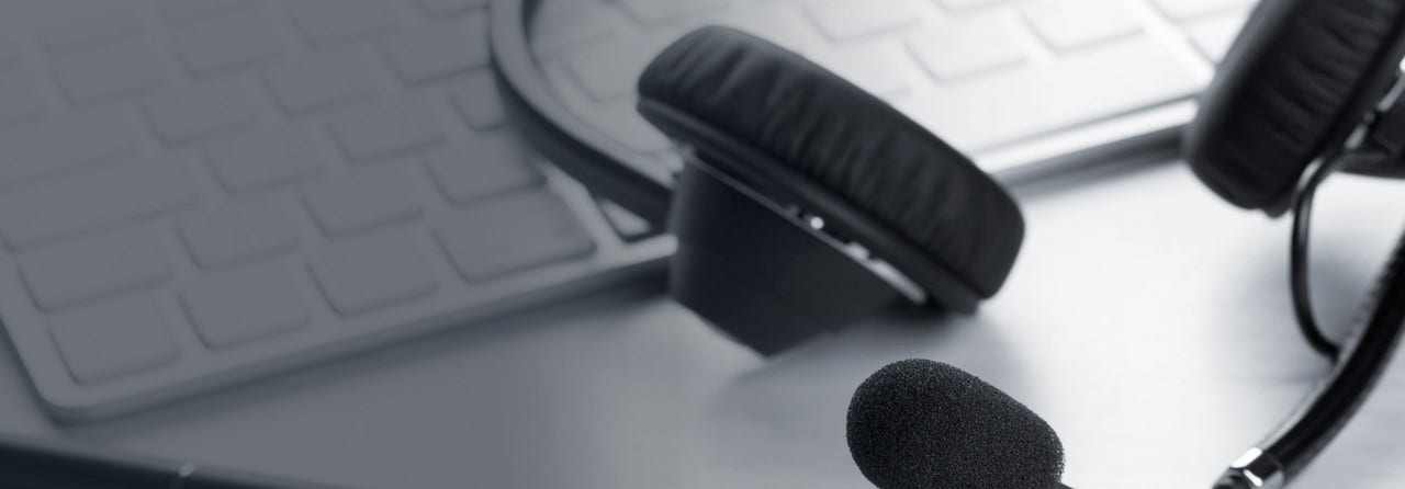 Phone headset resting on a keyboard