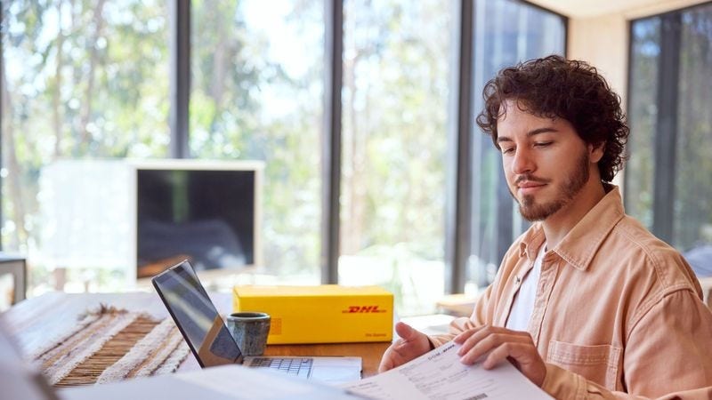 male business owner printing dhl express parcel shipping label