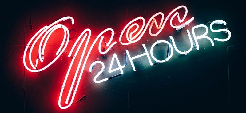 Neon sign reading 'open 24 hours'