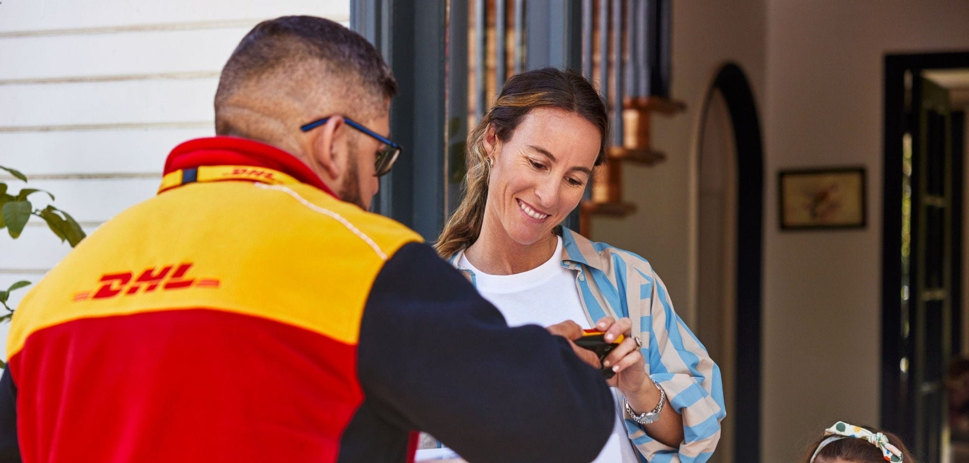 dhl express employee overseeing trade logistics with partner