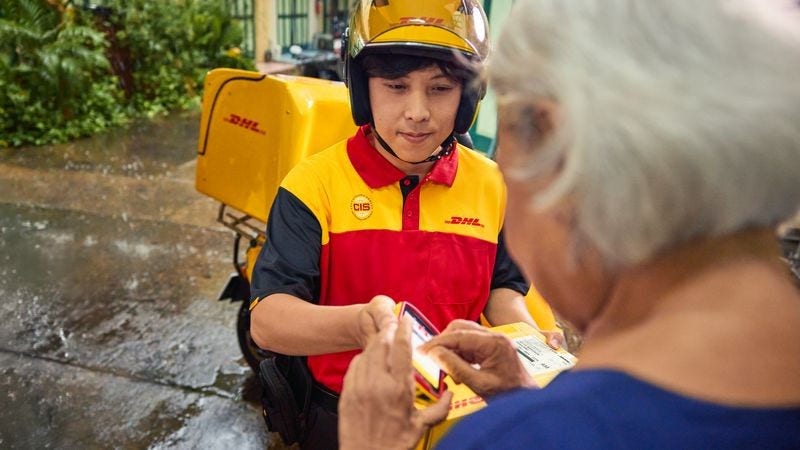 A DHL logistics employee getting a signature