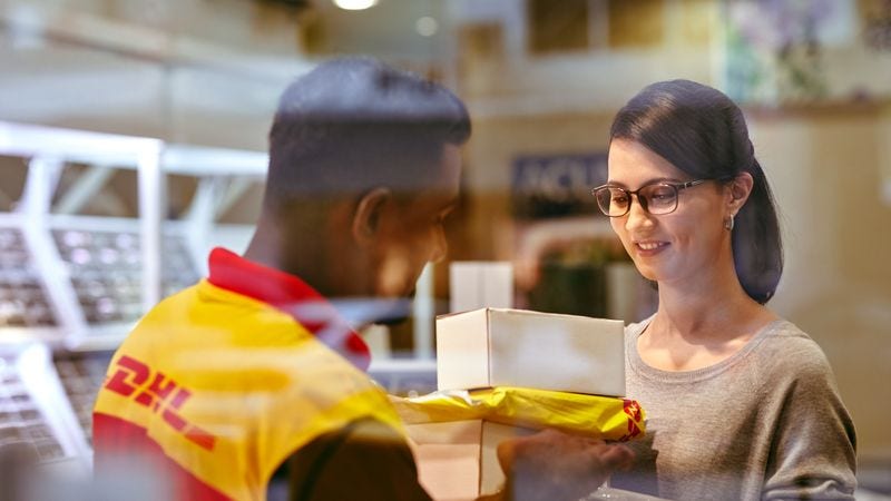 dhl express courier delivering packages to a woman