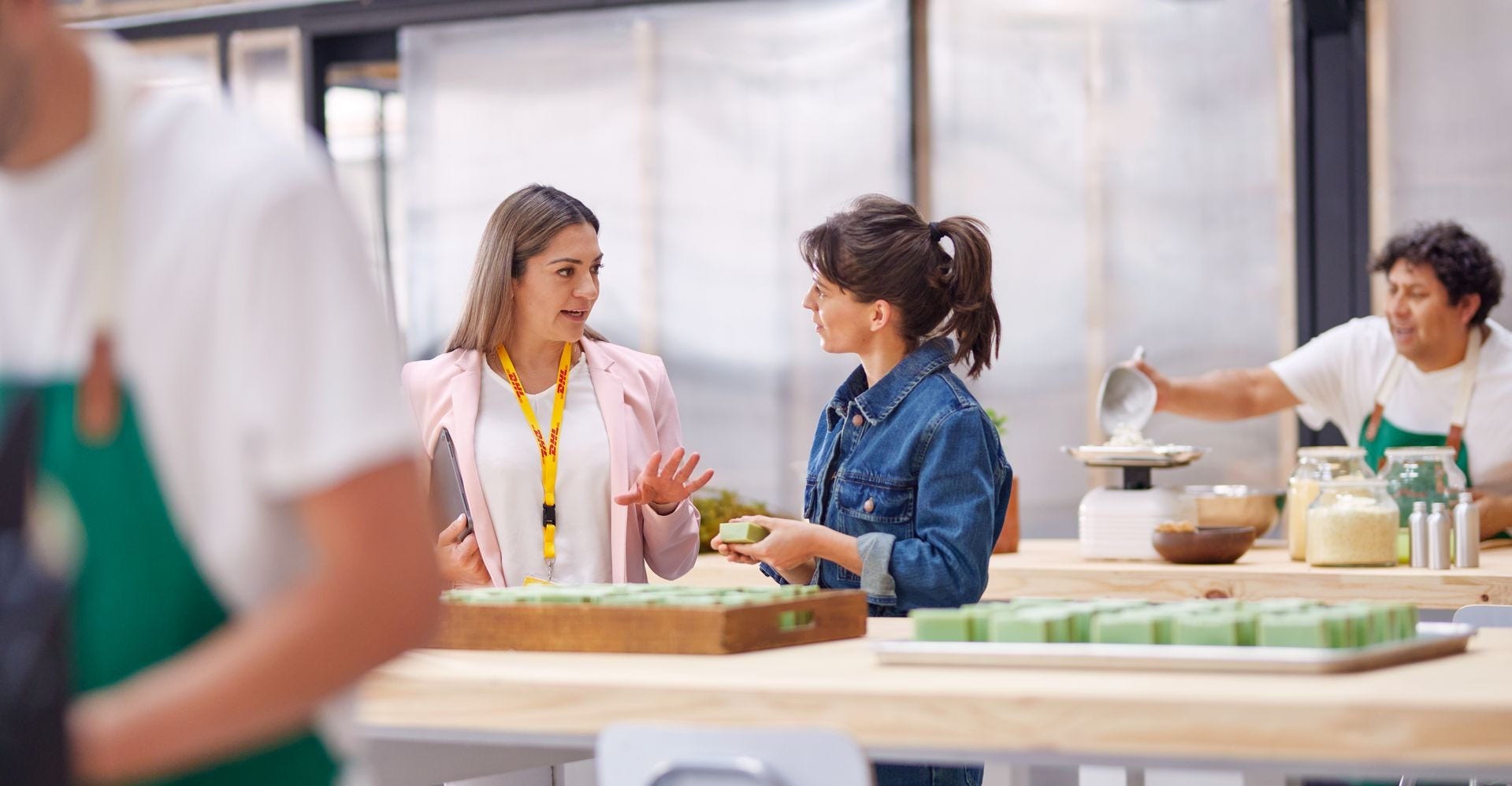 a female dhl expert explaining solutions on international product shipping to a startup owner