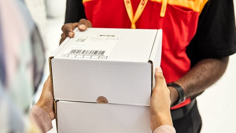 woman from pakistan handing over a parcel with leather goods to a dhl express employee for delivery
