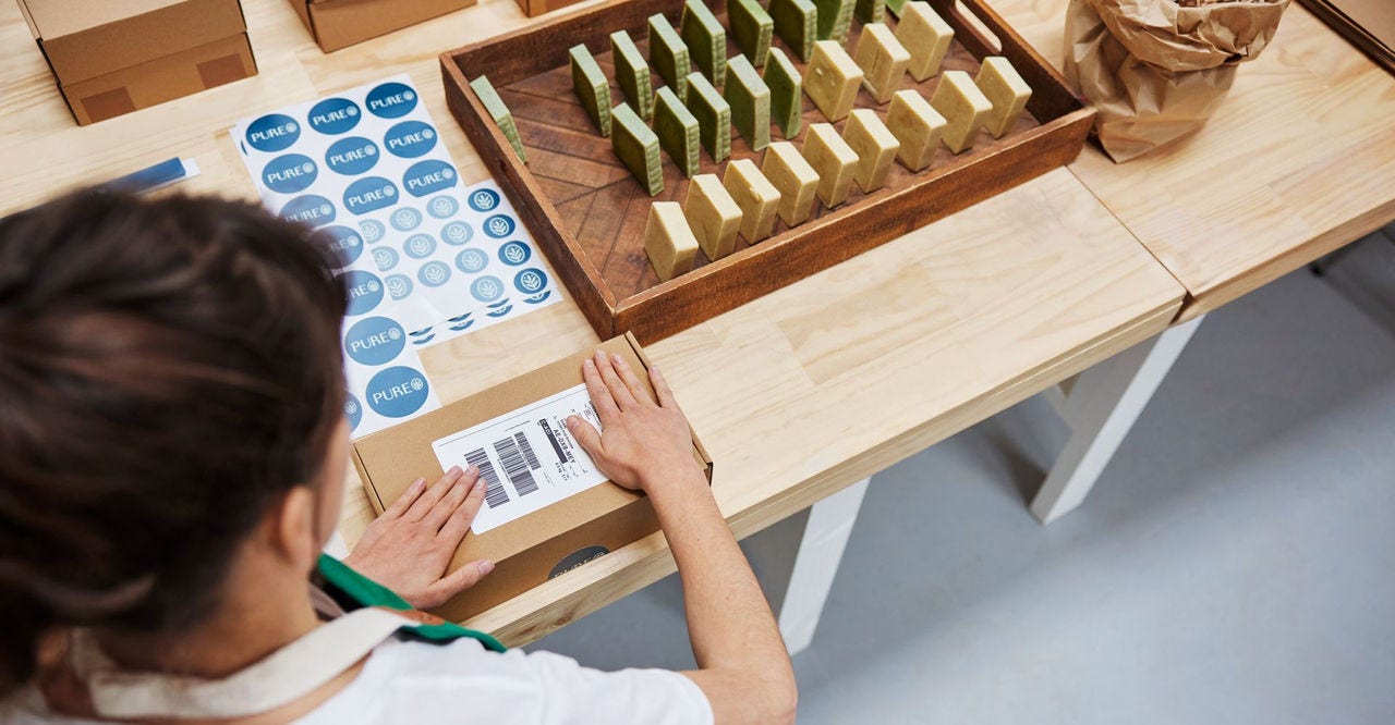 A crew is preparing skincare products before courier pickup service arrives