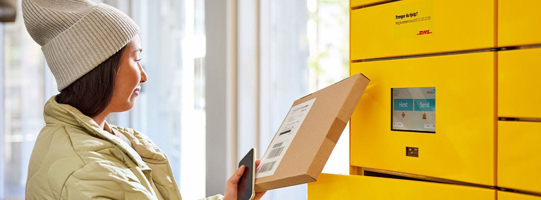 woman placing parcel in parcel locker