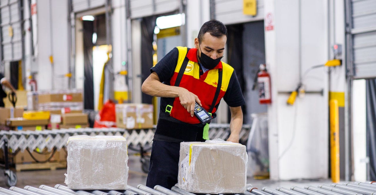 a dhl employee getting packages ready for international shipping