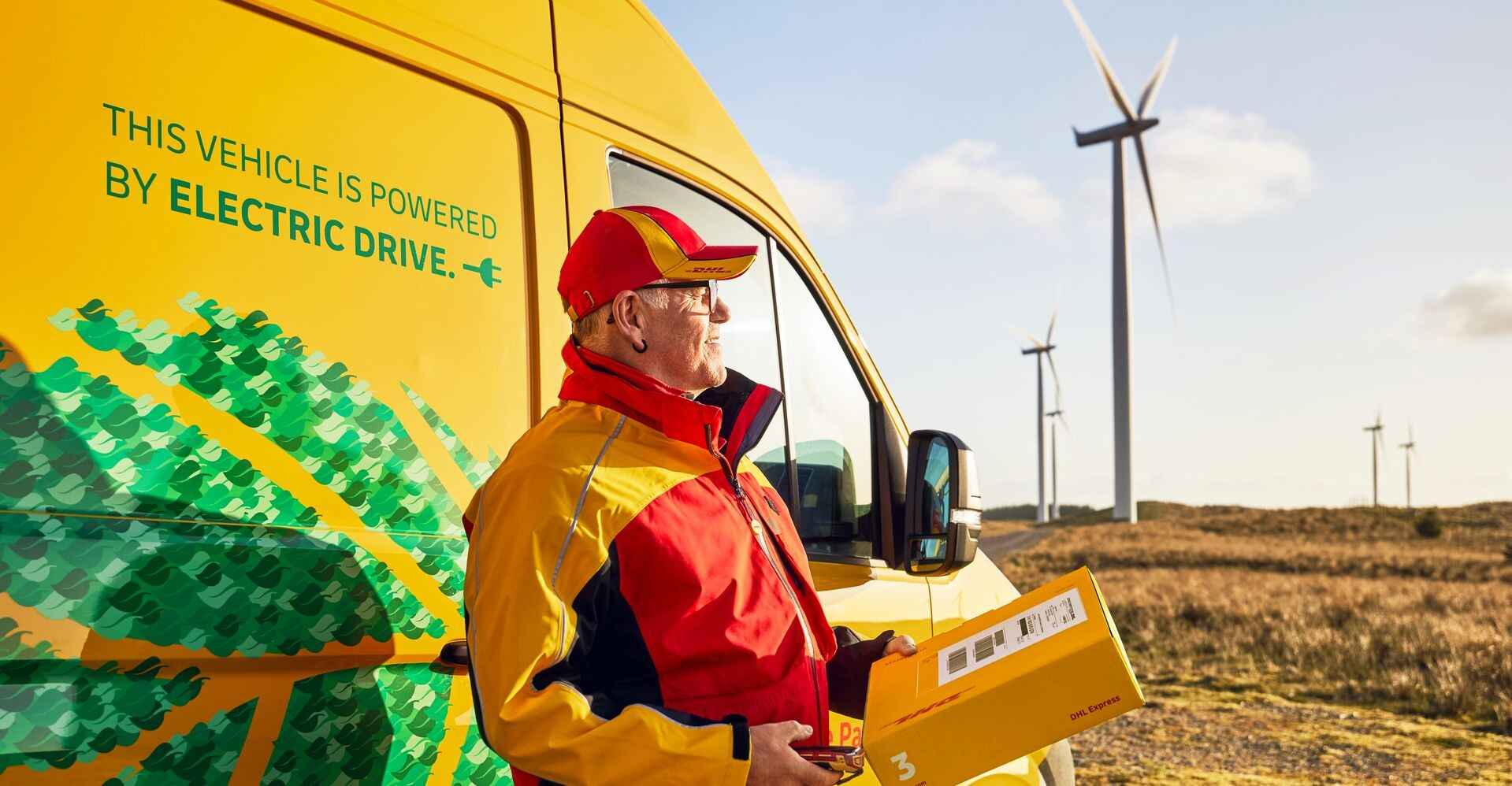 dhl courier standing outside an electric vehicle