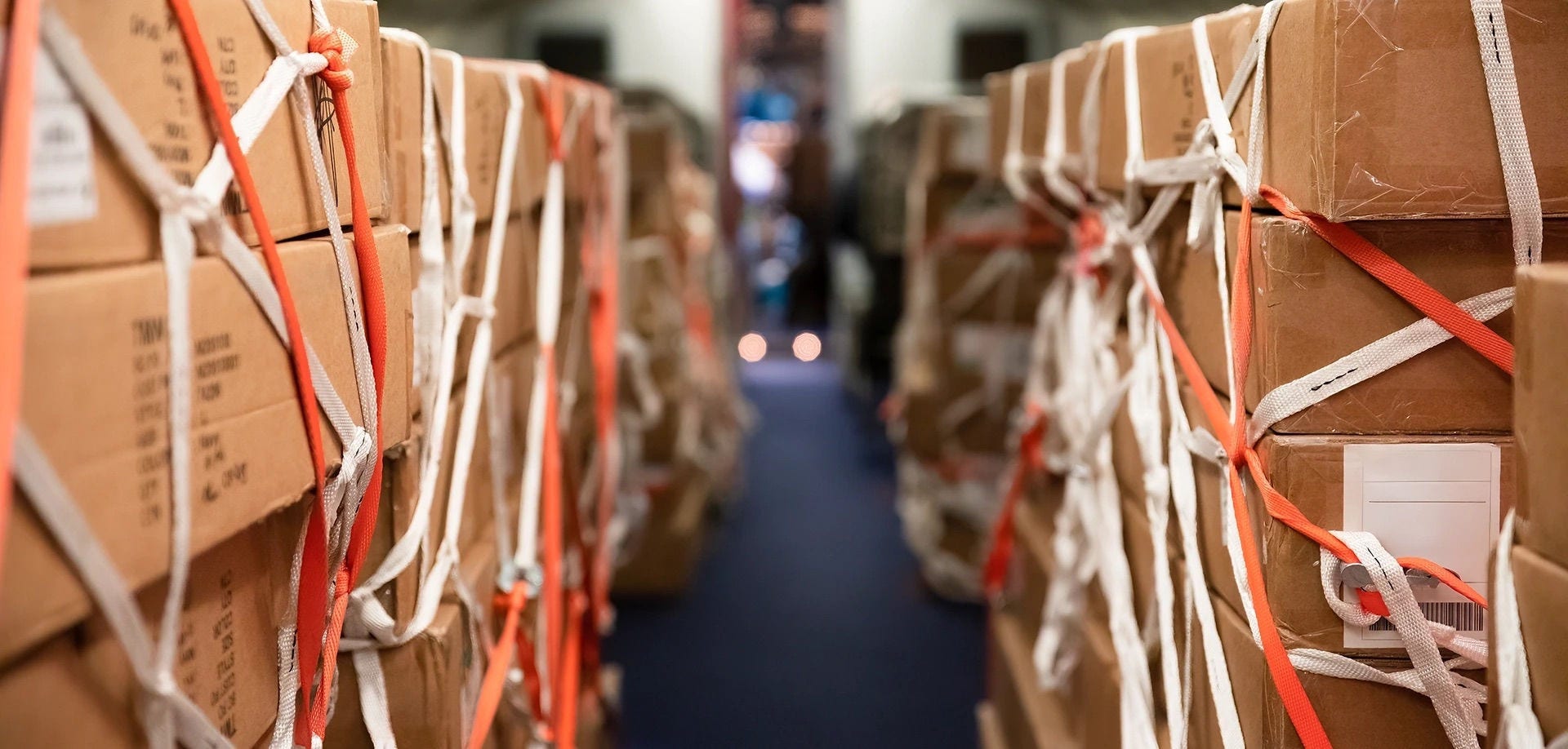Rows of strapped boxes in a warehouse, whose volume sets the freight cost