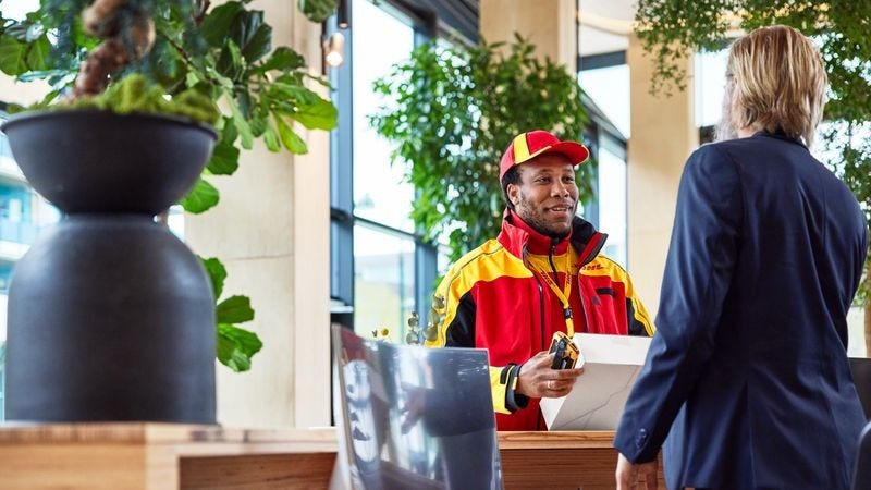 A New Zealand business owner talking to a DHL Express employee