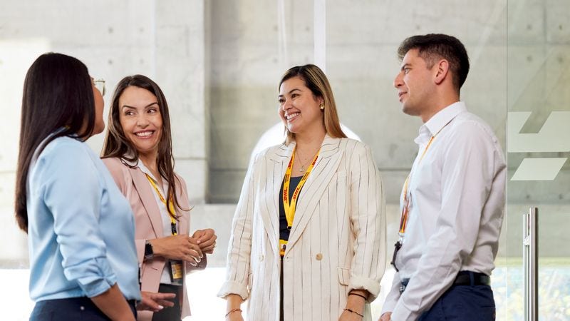 a group of dhl express employees discussing e-commerce logistics solutions