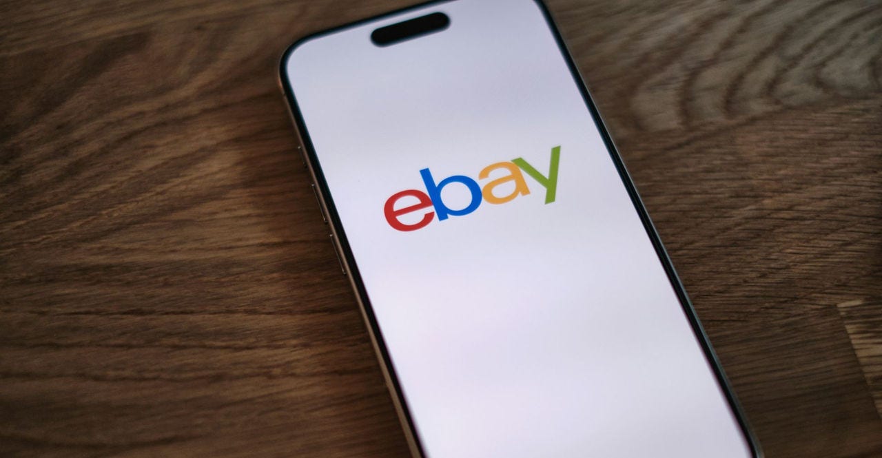 mobile phone on table displaying ebay logo