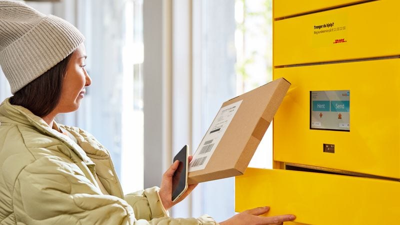 A woman takes a tracked and insured shipment to a DHL locker  