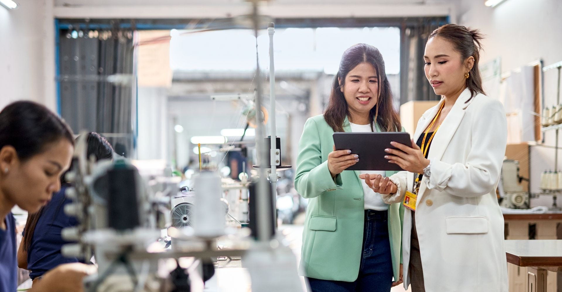 DHL Express employee discussing the benefits of return logistics to a business owner in Indonesia