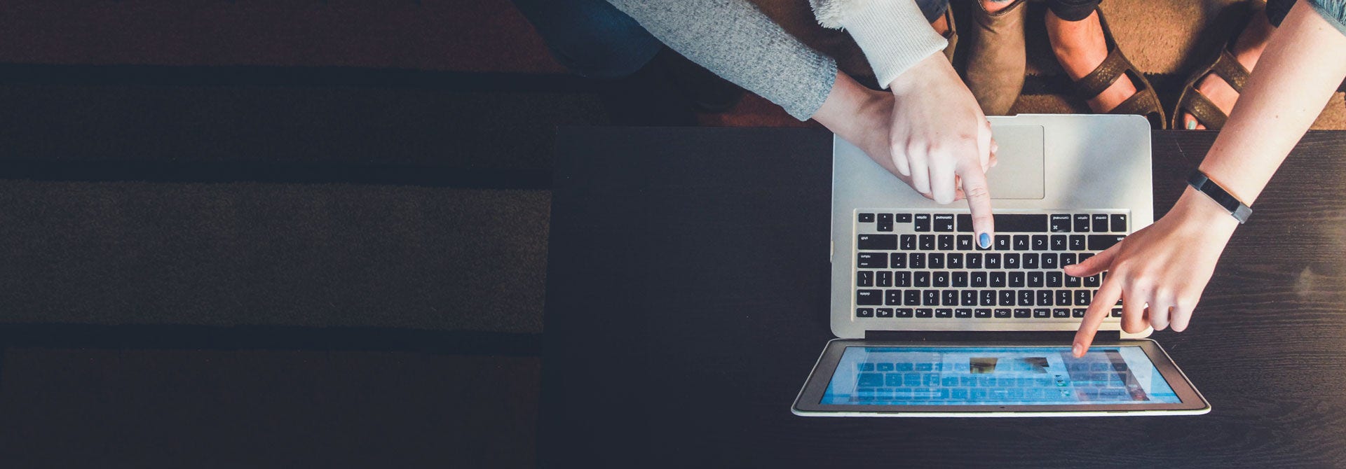 Hands typing on a laptop
