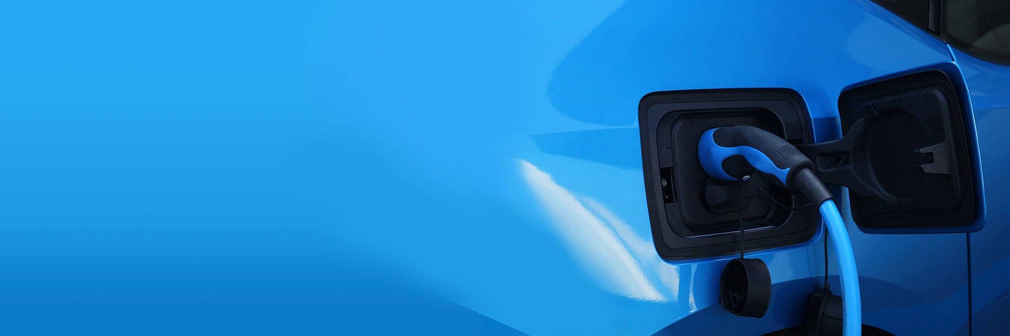 blue electric car being charged