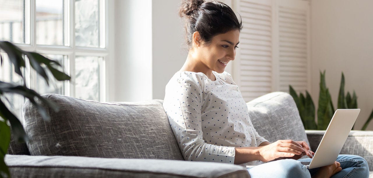 woman smiling at laptop screen