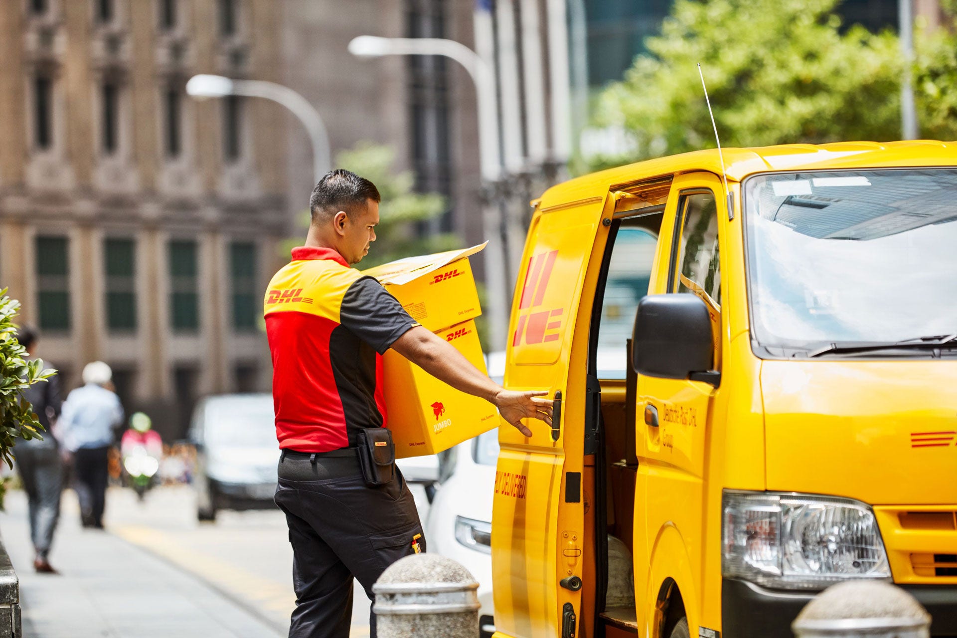 DHL parcel carrier next to his car