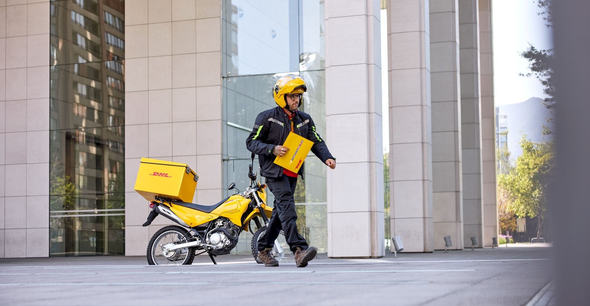 dhl rider holding an important document delivery envelope