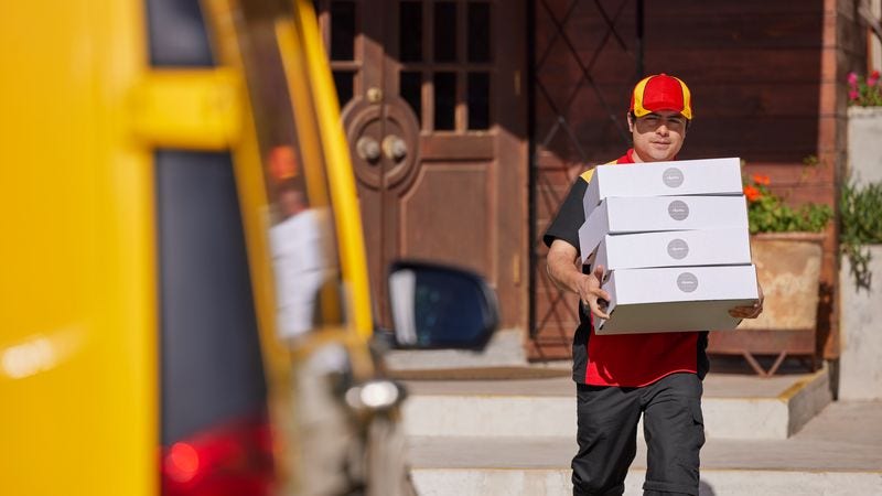  DHL employee picking up international ecommerce packages 