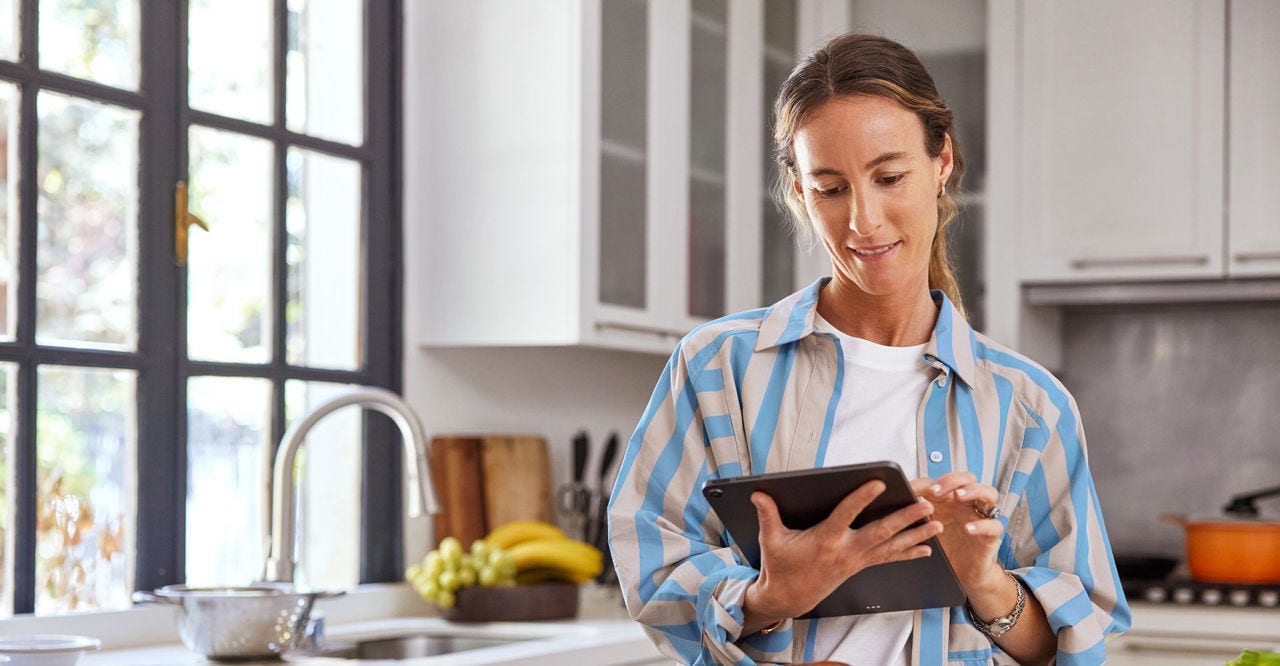 A woman booking e-commerce international shipping services on her tablet
