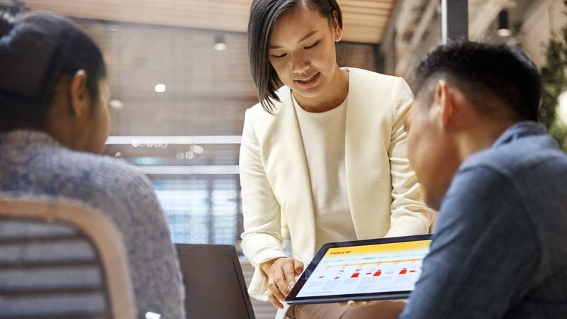 chinese business owner discussing website with partner