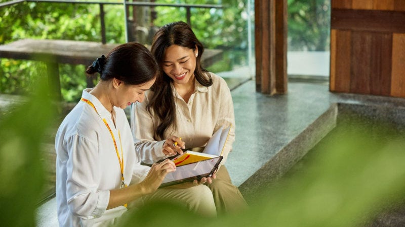business owner in Thailand being guided by a DHL employee on CBAM requirements