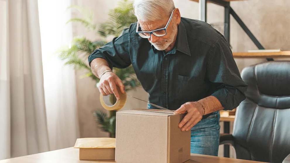 man wrapping parcel