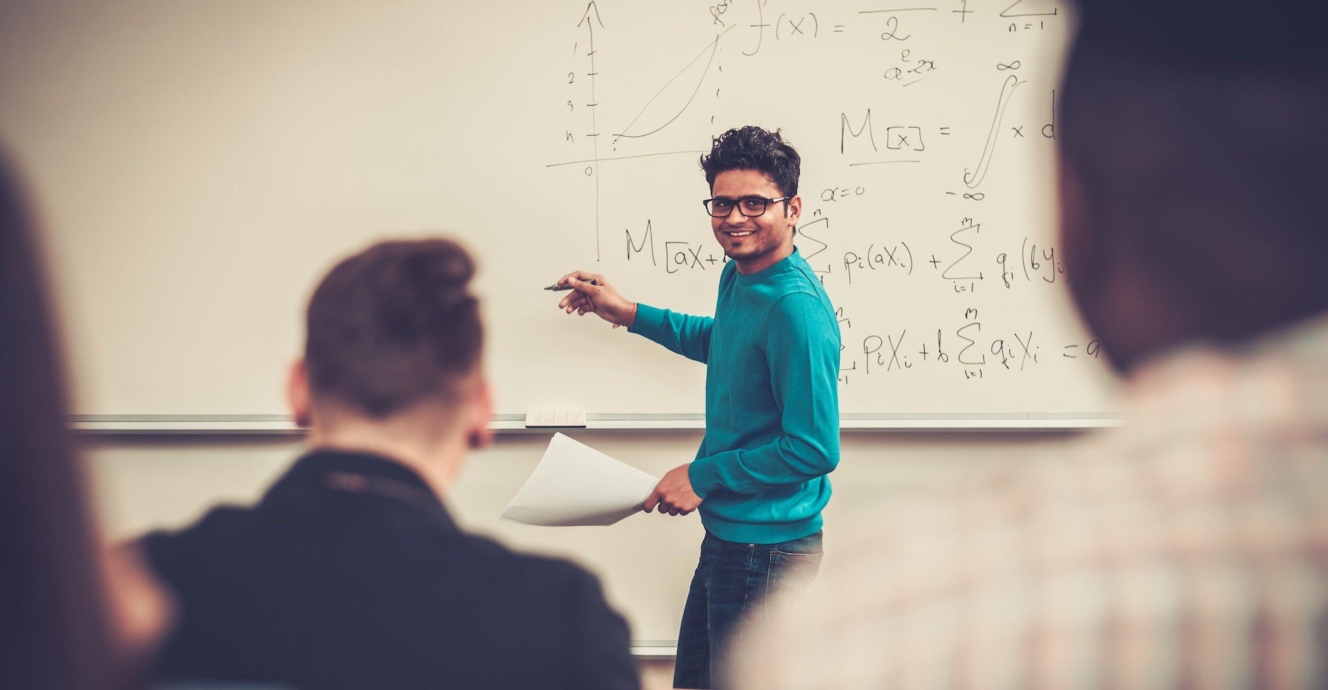 Multinational group of cheerful students taking an active part in a lesson while sitting in a lecture hall.; Shutterstock ID 393668236; purchase_order: 0018234; job: D0312973; client: DHL Express; other: DHL LK: Industry Specific Campaign 2022