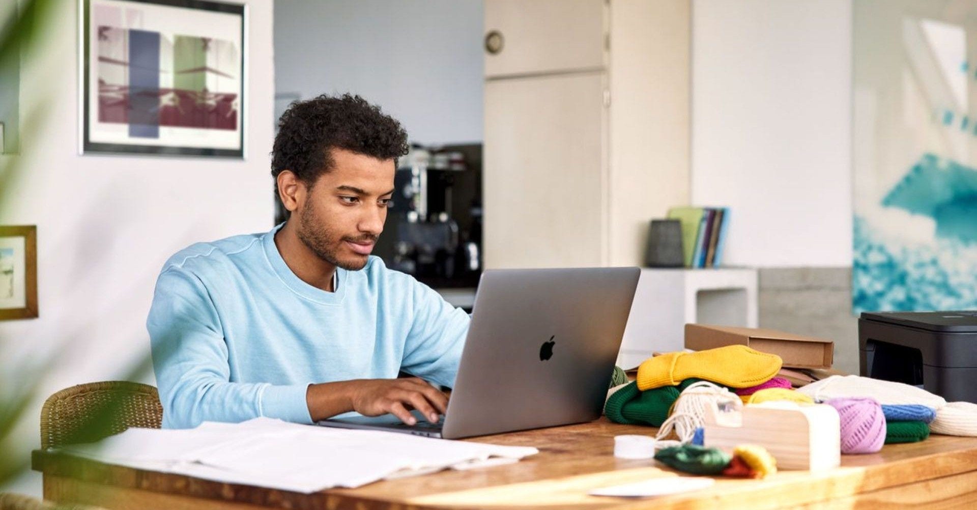a man runs his small business from home, surrounded by product
