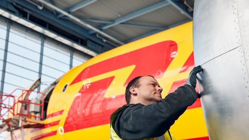 dhl logistics team member inspecting a cargo plane