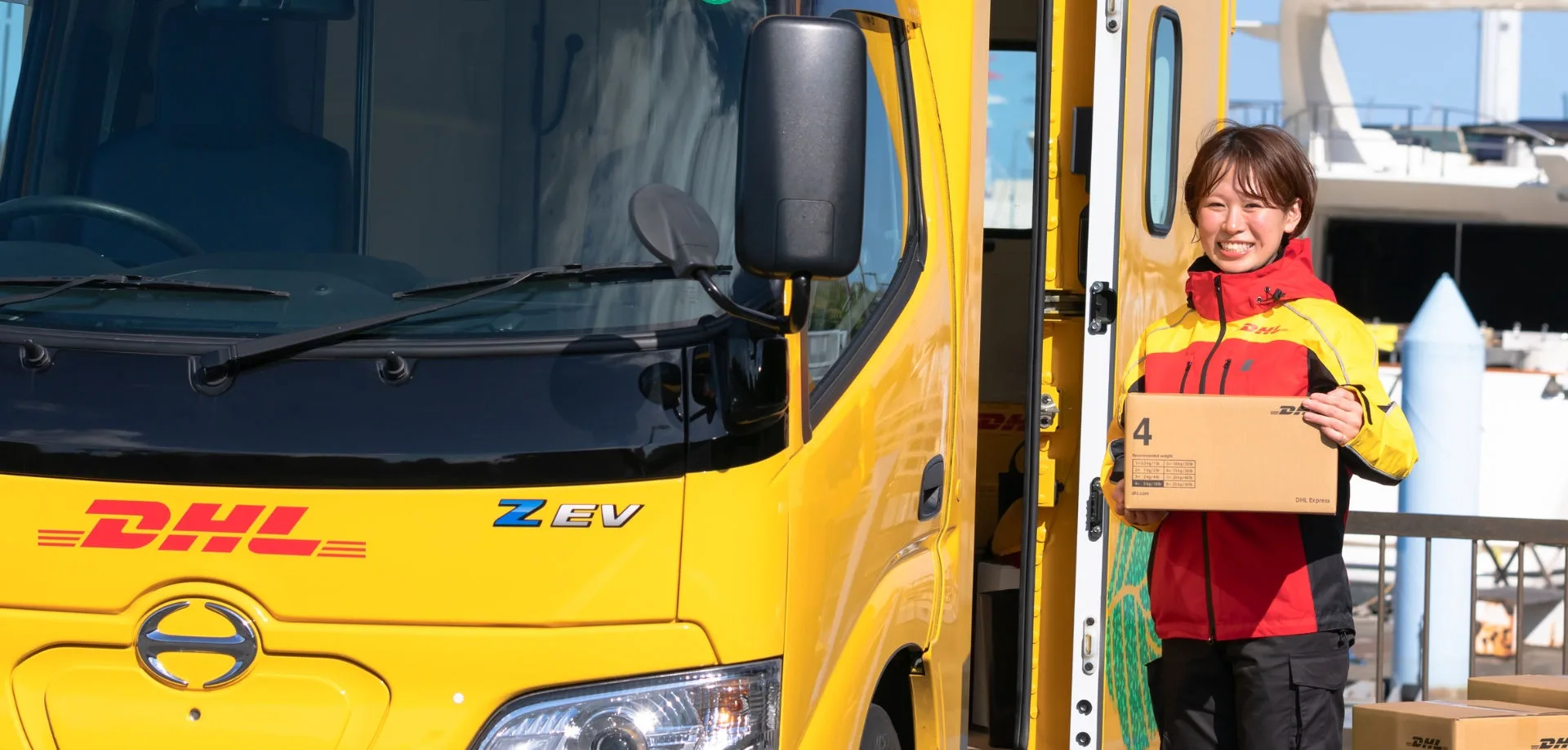 smiling dhl courier on delivery route in Japan