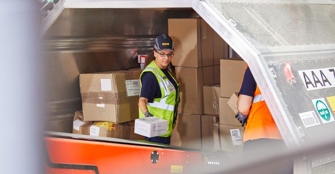 dhl workers packing shipments by volumetric weight