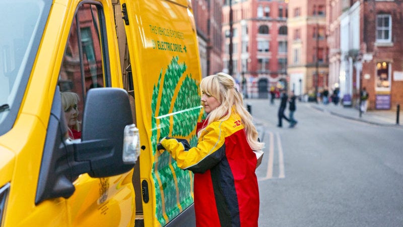 DHL Express courier delivering a package using sustainable logistics