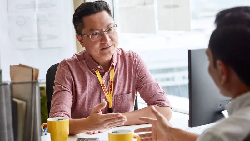 dhl employee helping with mobile phone import