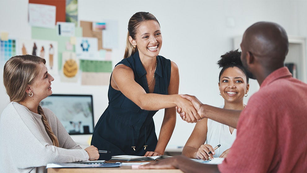 woman shaking man's hand