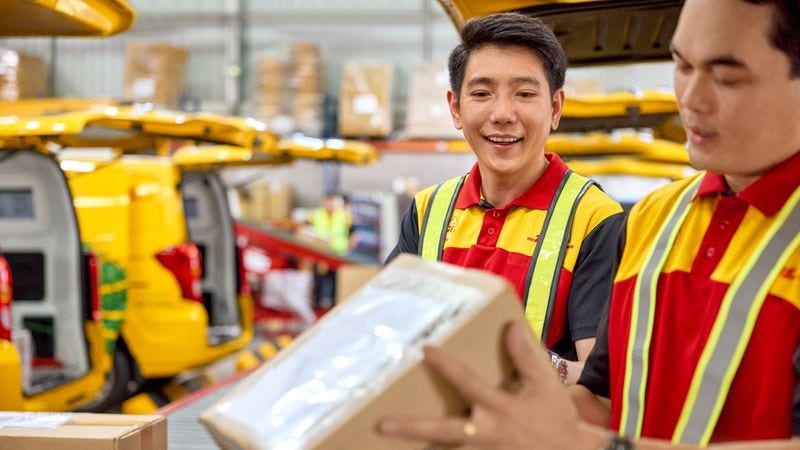 DHL Express employees preparing to deliver exported Filipino food delicacies