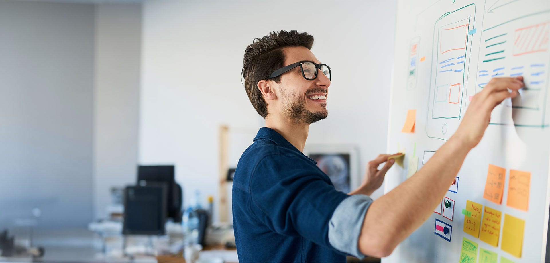 man writing on whiteboard