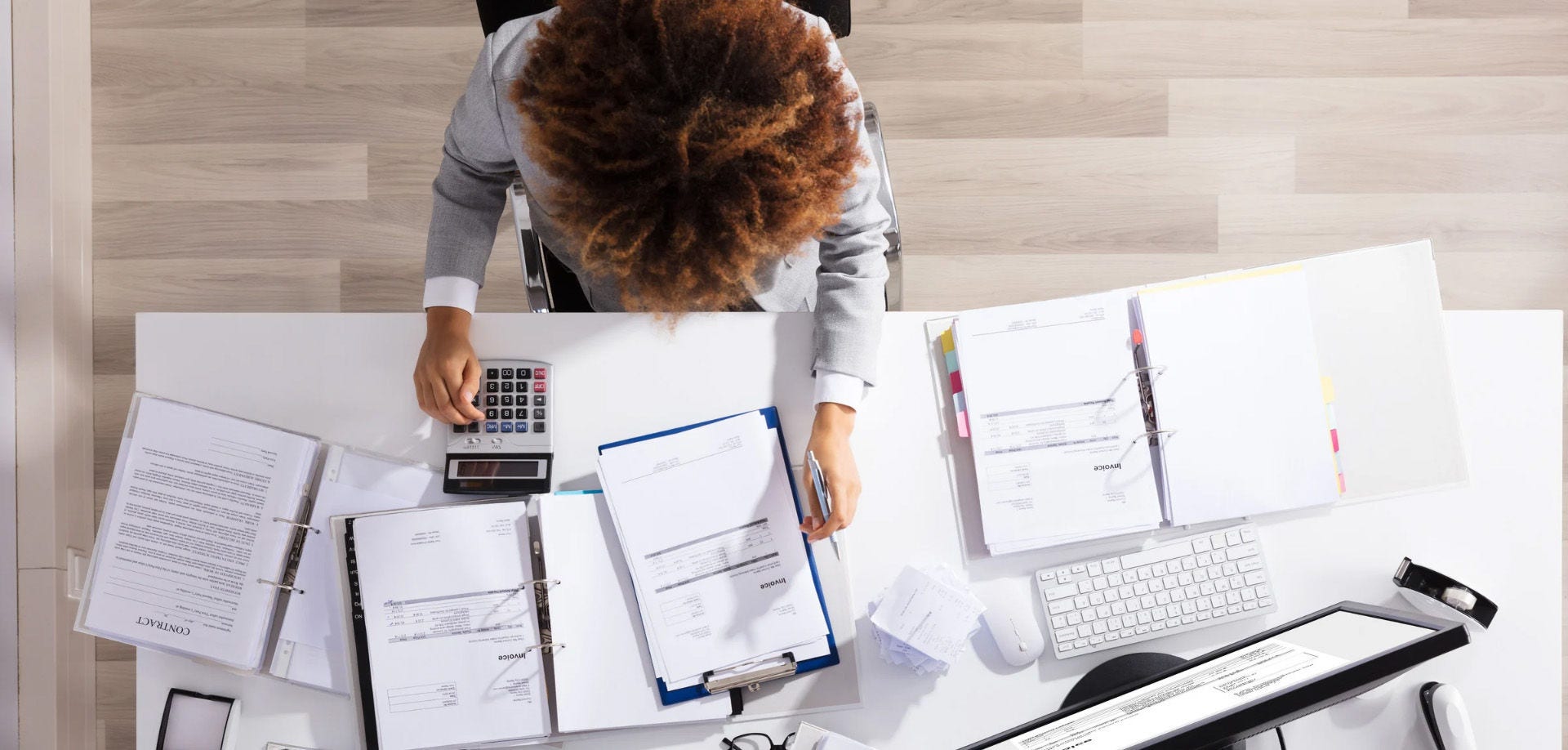 Printed proforma invoice on a desk next to a calculator and pen