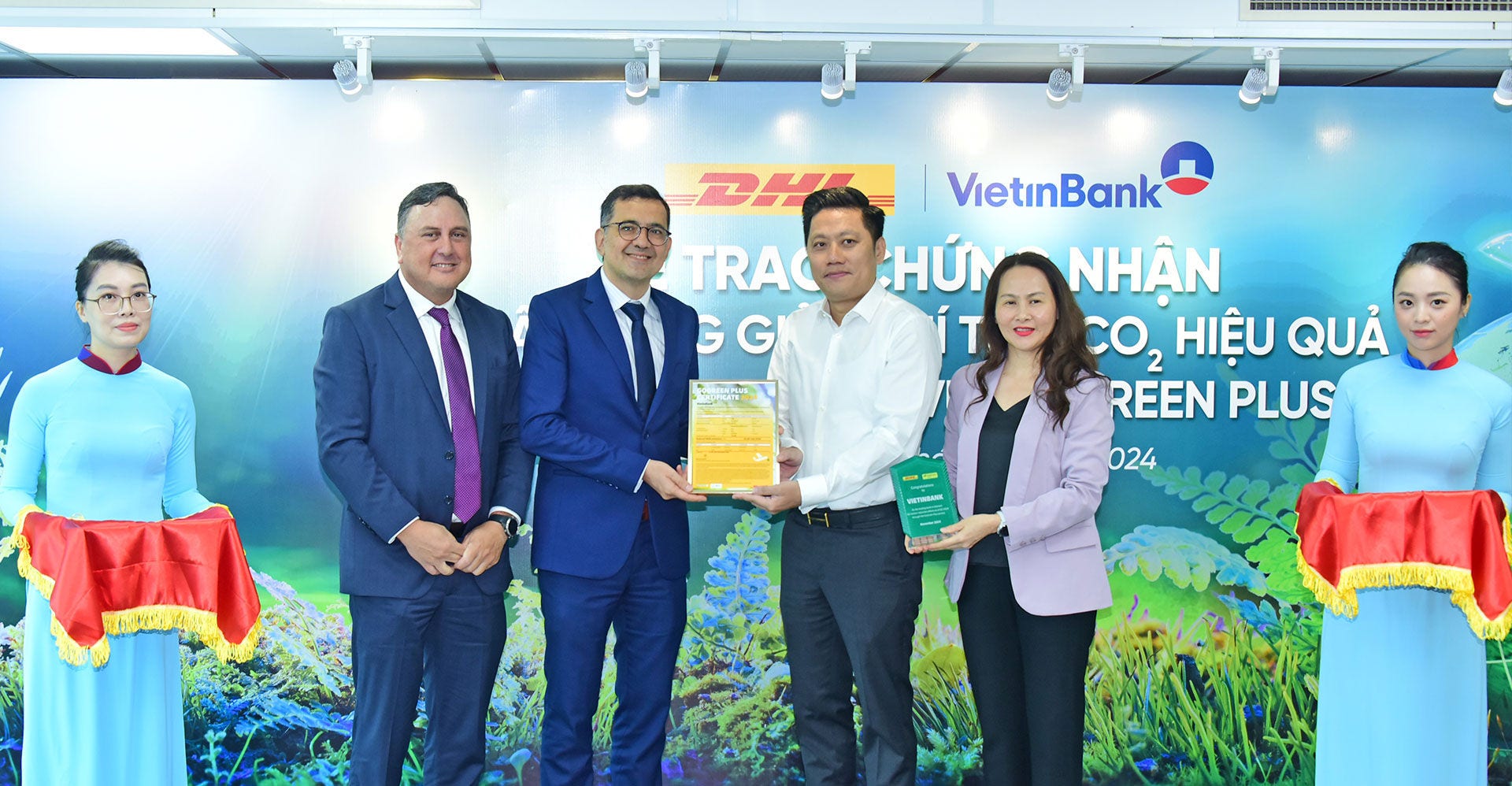 dhl express and vietinbank representatives at an event celebrating their decarbonization partnership