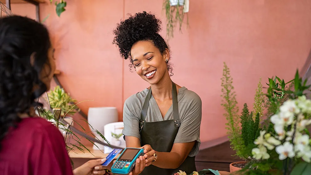 woman holding out payment device