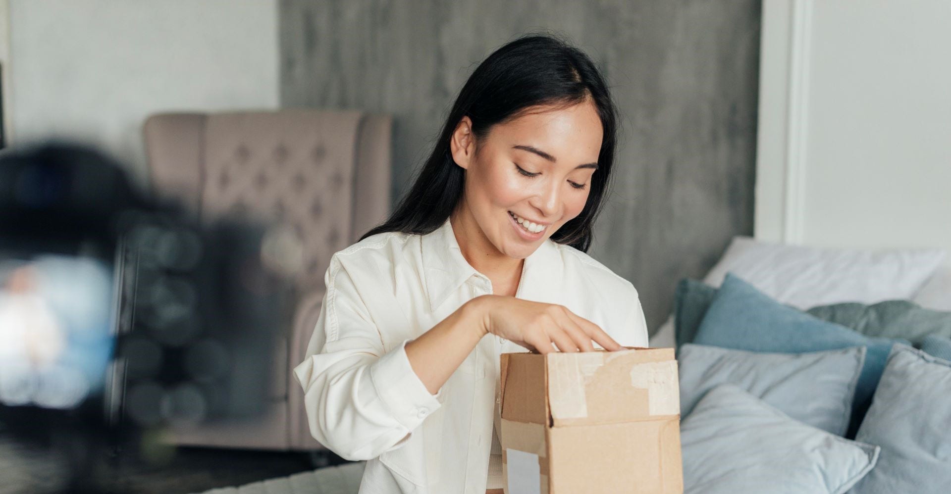a female recording herself unboxing a parcel