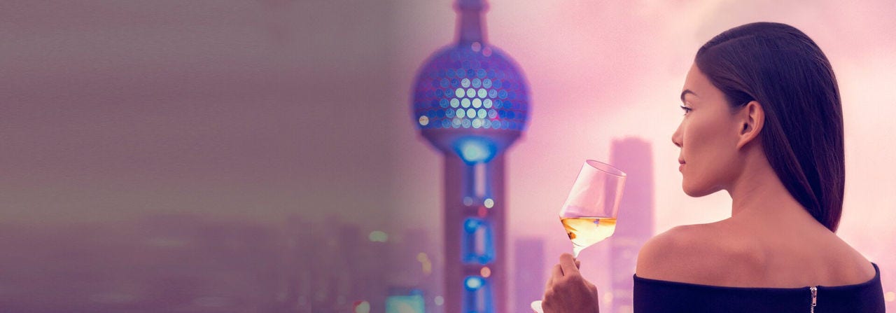 Young woman drinking wine on a Chinese rooftop