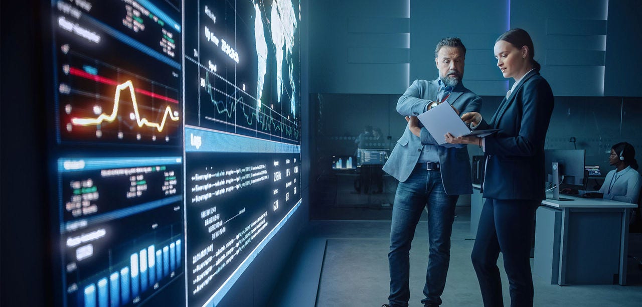 man and woman looking at laptop screen