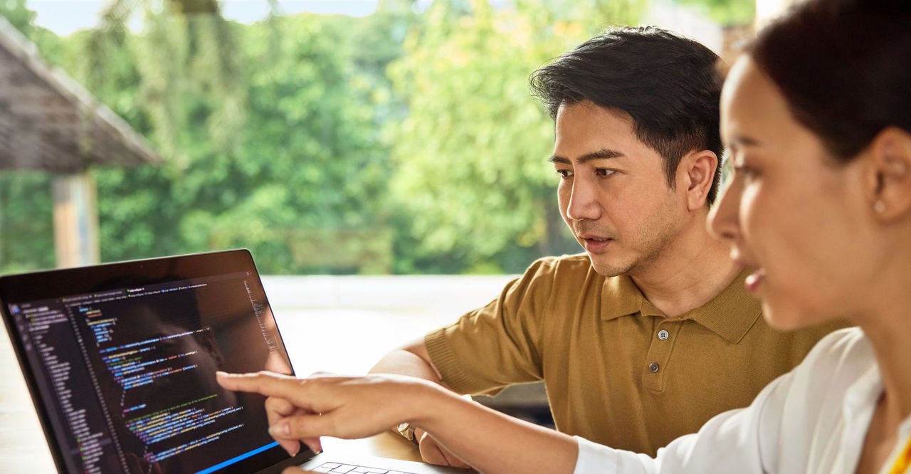 chinese business owner discussing website with partner