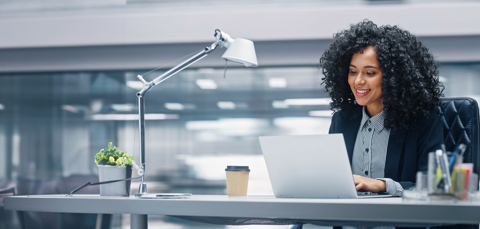 woman smiling at laptop screen
