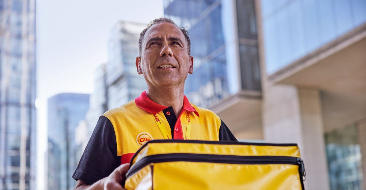 dhl express employee delivering medical products in a cooling box, ensuring cold storage and distribution in cambodia
