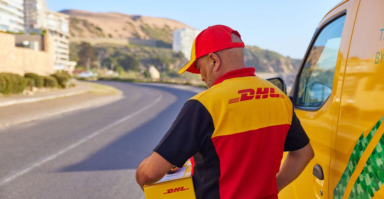 An electric DHL van on the road